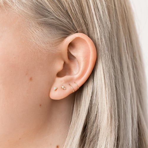 Zlatá piercing náušnica s bielymi topásmi Rossi