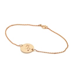 Zlatý náramok so znamením a granátom Kozorožec